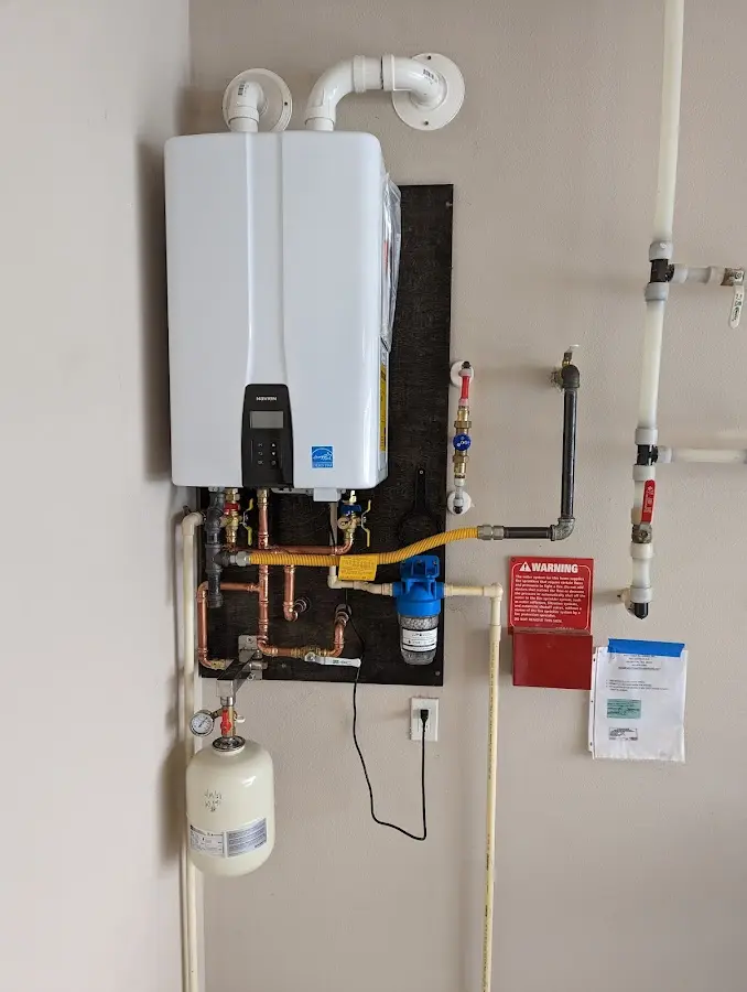 Professional plumber installing copper piping in a Willits home